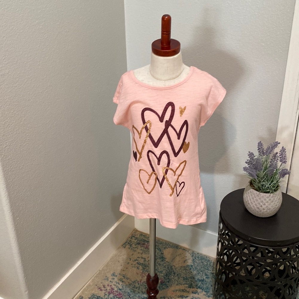 Adorable, pink tea with detail in the back in a little bit of a ruffle